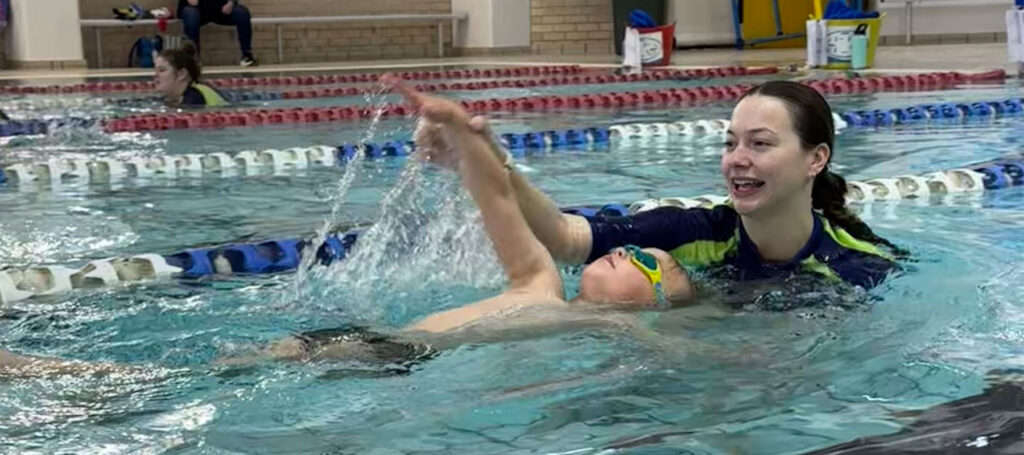 Student and instructor in swimming lessons